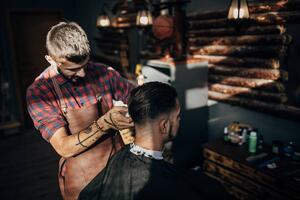 Fotografija One hairdresser cutting hair of a, South_agency