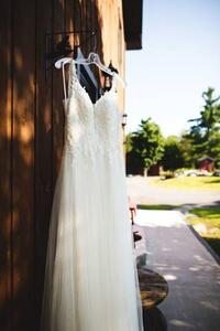 Umjetnička fotografija Beautiful white wedding dress hanging elegantly, Wirestock, (26.7 x 40 cm)