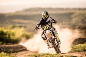 Fotografija Man on dirt bike racing on dirt road in nature., skynesher