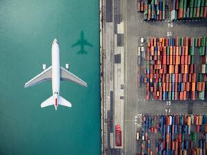 Ilustracija Airplane flying over container port, Orbon Alija