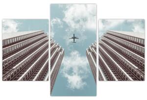 Slika aviona između zgrada (90x60 cm)