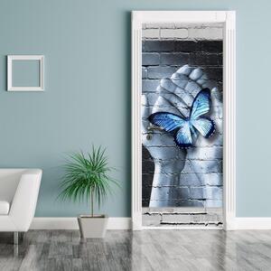 Foto tapeta za vrata - Plavi leptir na dlanovima (95x205cm)