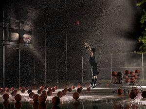 Fotografija Man shooting basketball at night in, Adam Weiss