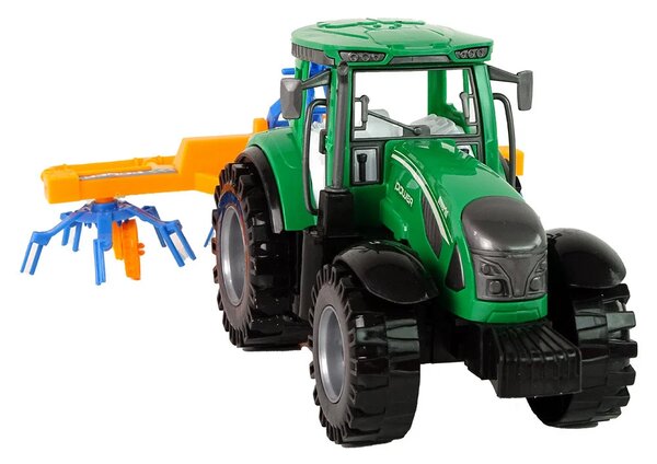 Zeleni traktor s narančastim i plavim pogonom trenja grablja
