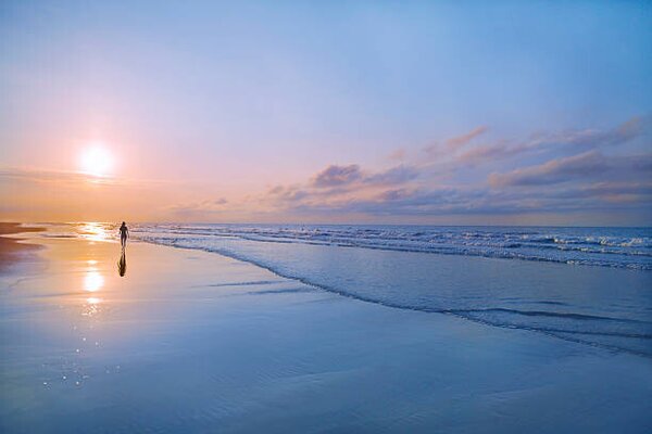 Umjetnička fotografija Person walking on beach at sunrise, Shannon Fagan, (40 x 26.7 cm)
