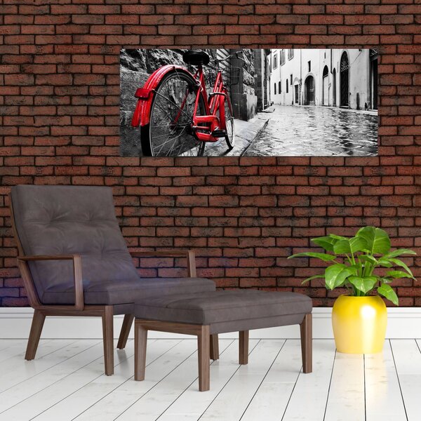 Slika rdečega kolesa na tlakovani ulici (120x50 cm)