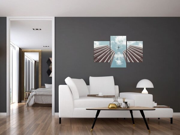 Slika aviona između zgrada (90x60 cm)